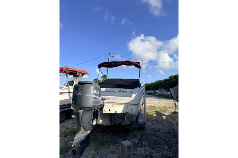Slide: The Image of 2002 Sea Ray 225 Weekender boat with Yamaha outboard motor, parked outdoors. - 7