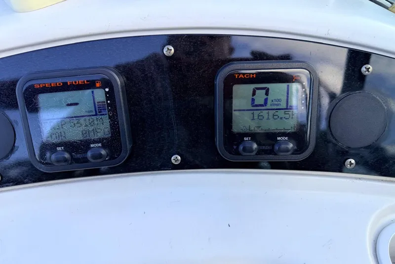 Slide: The Image of Dashboard of a 2002 Sea Ray 225 Weekender boat showing speed and tachometer gauges. - 4