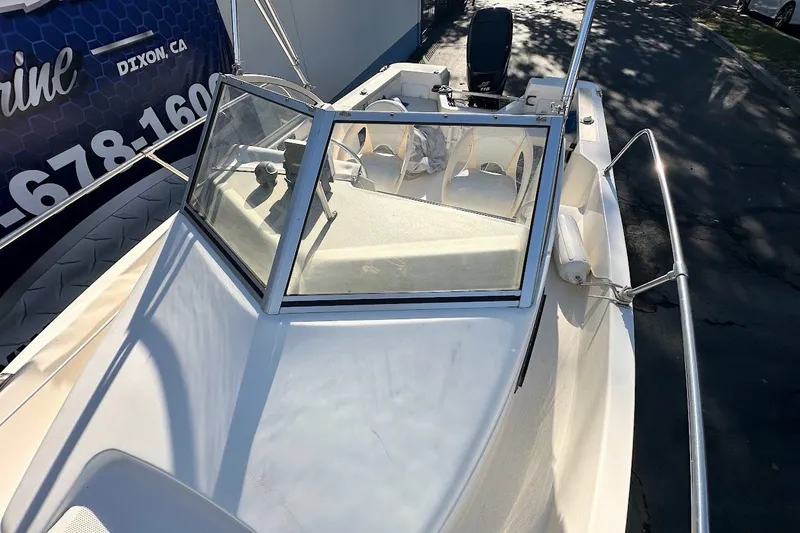 Slide: The Image of 2005 Trophy 1802 Walkaround boat with windshield and seating, parked outdoors. - 9