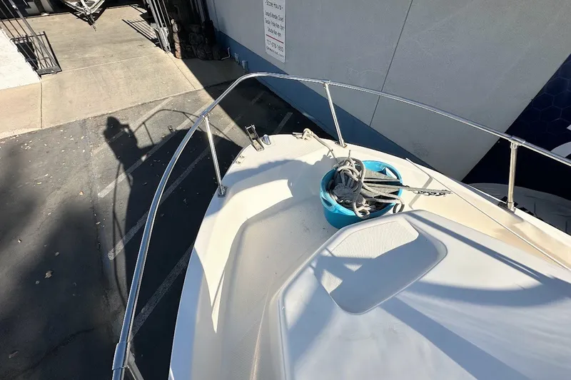 Slide: The Image of 2005 Trophy 1802 Walkaround boat deck with anchor and rope in a blue bucket. - 8