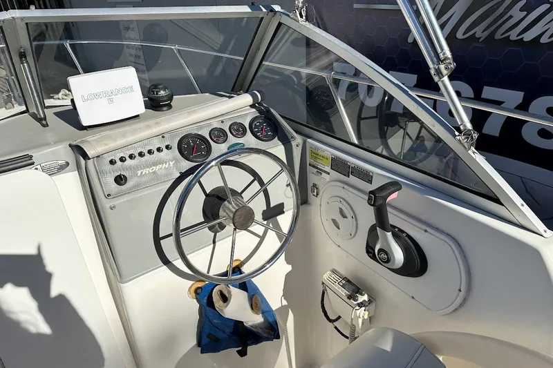 Slide: The Image of 2005 Trophy 1802 Walkaround boat dashboard with steering wheel and Lowrance equipment. - 22