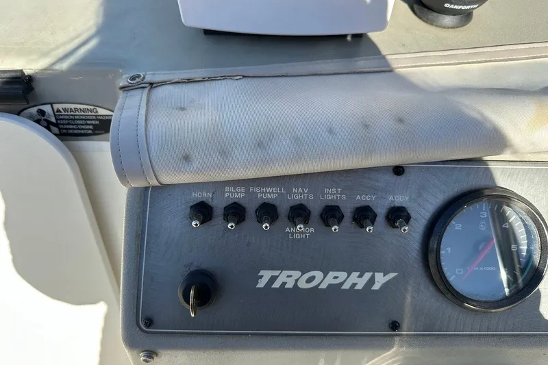 Slide: The Image of Control panel of a 2005 Trophy 1802 Walkaround boat with switches and gauge. - 26