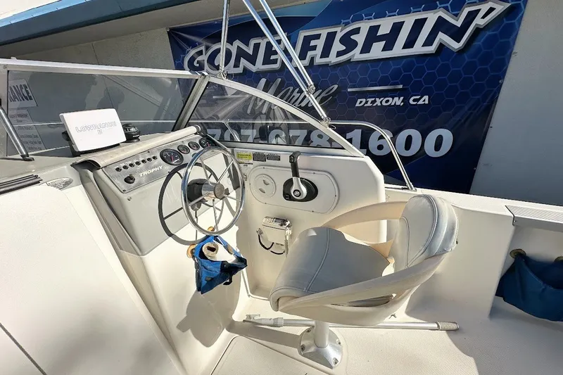 Slide: The Image of 2005 Trophy 1802 Walkaround boat cockpit with steering wheel and controls. - 21