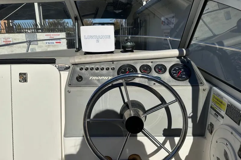 Slide: The Image of 2005 Trophy 1802 Walkaround boat dashboard with steering wheel and Lowrance device. - 23