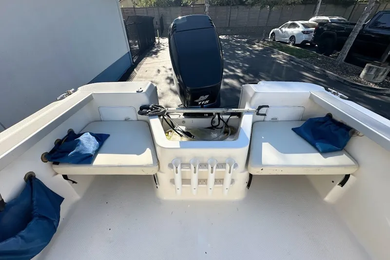 Slide: The Image of 2005 Trophy 1802 Walkaround boat interior with seating and motor view. - 16