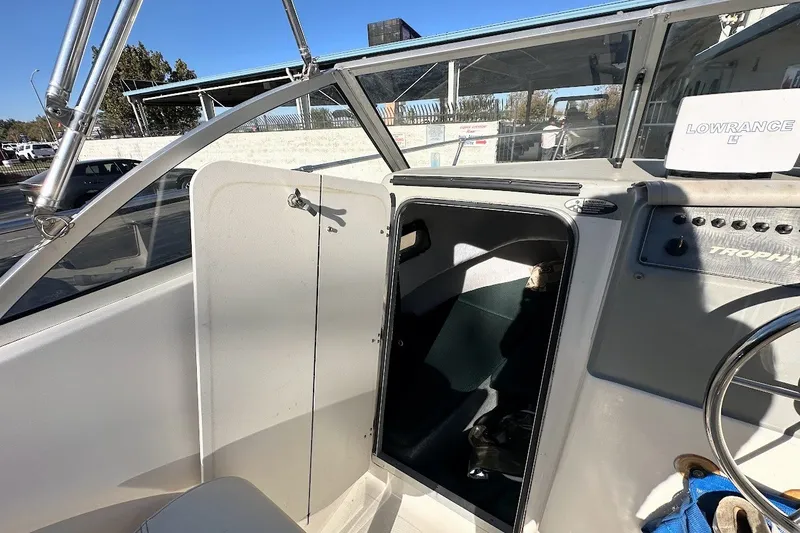 Slide: The Image of 2005 Trophy 1802 Walkaround boat interior with steering wheel and cabin entrance. - 10