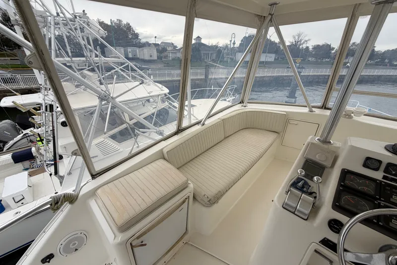 Slide: The Image of 2001 Ocean Yachts 48 Super Sport cockpit with seating and control panel, docked at marina. - 23