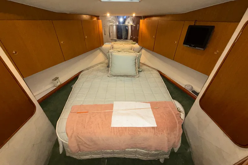 Slide: The Image of Luxurious cabin interior of 2001 Ocean Yachts 48 Super Sport with cozy bedding. - 50