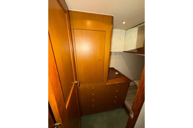 Slide: The Image of Interior cabin of 2001 Ocean Yachts 48 Super Sport with wooden cabinetry and cozy sleeping area. - 40