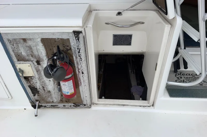 Slide: The Image of 2001 Ocean Yachts 48 Super Sport engine room access with fire extinguisher and safety equipment. - 57