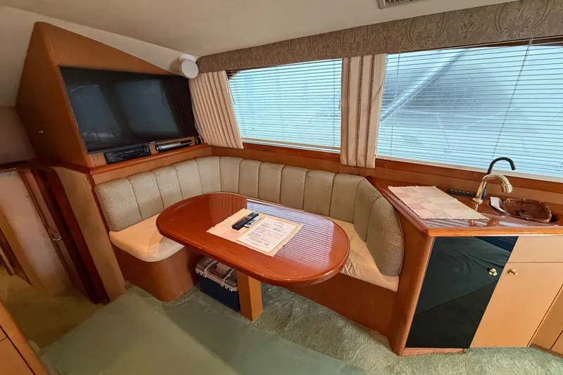 Slide: The Image of Luxurious interior of 2001 Ocean Yachts 48 Super Sport with cozy seating and elegant wood finishes. - 27