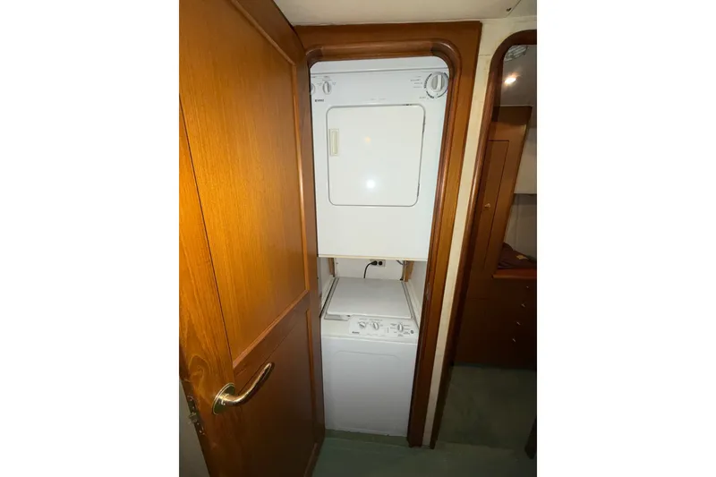 Slide: The Image of Stacked washer and dryer in 2001 Ocean Yachts 48 Super Sport interior. - 42