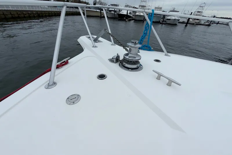 Slide: The Image of Bow of 2001 Ocean Yachts 48 Super Sport with anchor and railing in marina. - 54