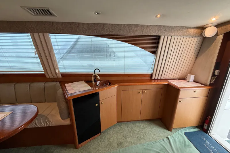 Slide: The Image of Interior of 2001 Ocean Yachts 48 Super Sport with wood cabinetry and seating area. - 26