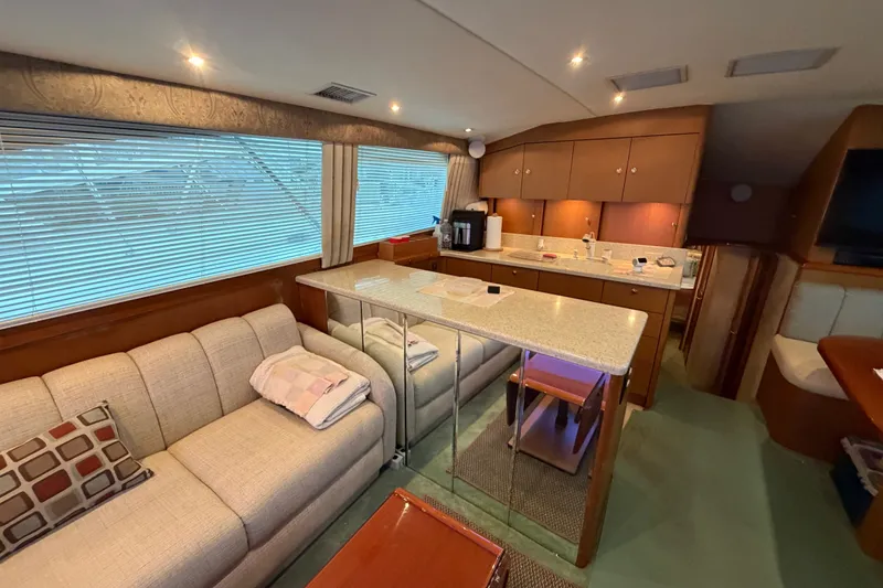 Slide: The Image of Luxurious interior of 2001 Ocean Yachts 48 Super Sport with cozy seating and modern kitchen. - 33