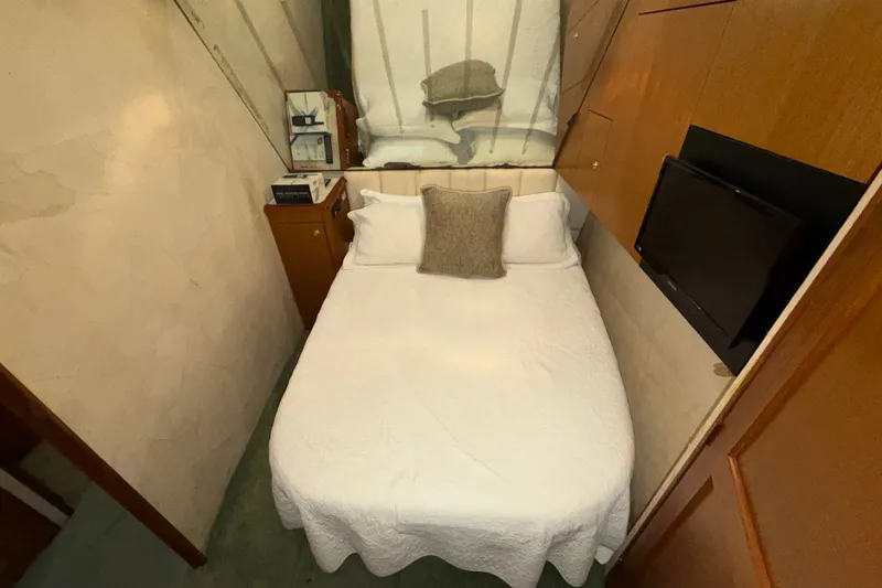 Slide: The Image of Cozy bedroom in 2001 Ocean Yachts 48 Super Sport with TV and storage. - 44