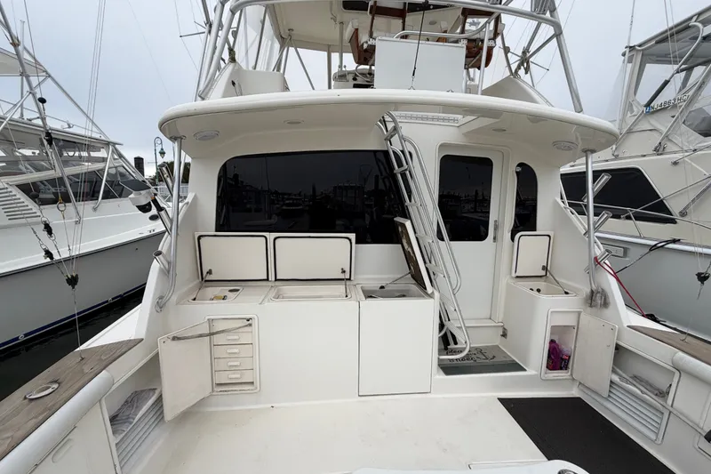 Slide: The Image of 2001 Ocean Yachts 48 Super Sport boat deck with fishing equipment and storage compartments. - 15