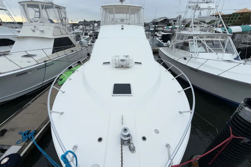 Slide: The Image of 2001 Ocean Yachts 48 Super Sport docked at marina, surrounded by other boats. - 55