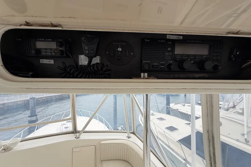 Slide: The Image of Control panel of a 2001 Ocean Yachts 48 Super Sport, featuring communication equipment. - 66