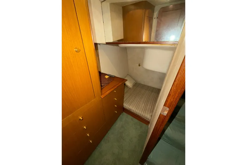 Slide: The Image of 2001 Ocean Yachts 48 Super Sport cabin interior with wooden cabinetry and cozy bed. - 41