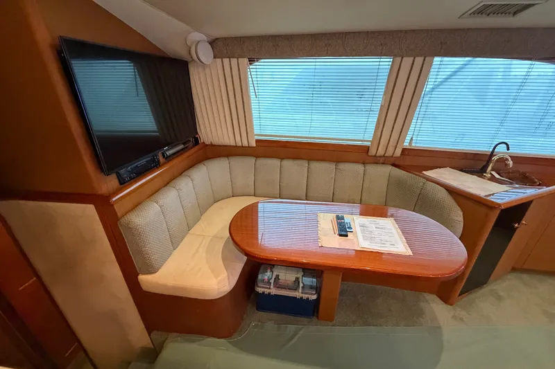 Slide: The Image of Interior of 2001 Ocean Yachts 48 Super Sport with cozy seating and table. - 28