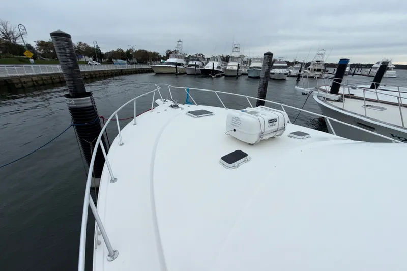Slide: The Image of Bow view of 2001 Ocean Yachts 48 Super Sport docked at marina. - 52