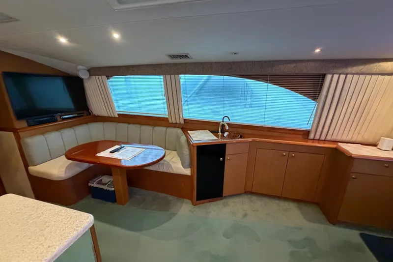 Slide: The Image of Interior of 2001 Ocean Yachts 48 Super Sport with dining area and kitchenette. - 35