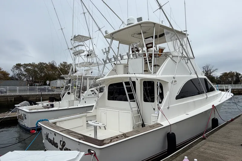 The Image of 2001 Ocean Yachts 48 Super Sport docked, showcasing sleek design and spacious deck. - 4