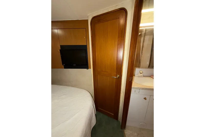 Slide: The Image of Interior of 2001 Ocean Yachts 48 Super Sport with wooden door and mounted TV. - 45
