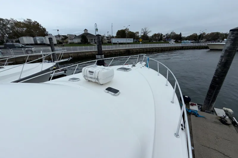Slide: The Image of 2001 Ocean Yachts 48 Super Sport docked at a marina, view of the bow. - 51