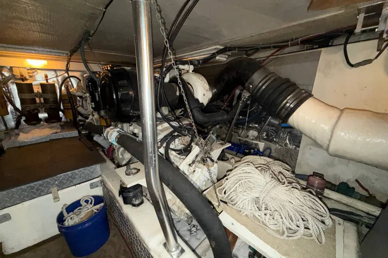 Slide: The Image of Engine room of a 2001 Ocean Yachts 48 Super Sport, featuring mechanical components and ropes. - 58