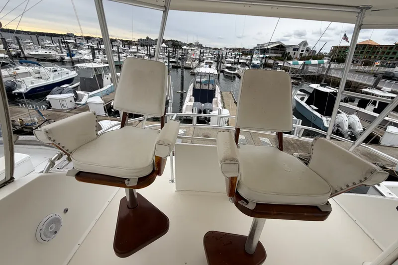Slide: The Image of 2001 Ocean Yachts 48 Super Sport helm chairs overlooking marina. - 20