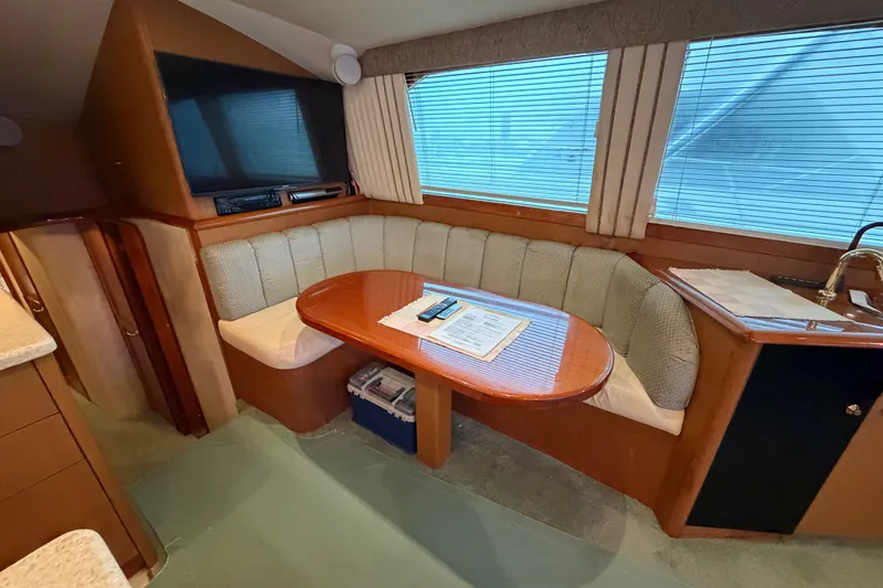 Slide: The Image of Interior of 2001 Ocean Yachts 48 Super Sport with cozy dining area and TV. - 37