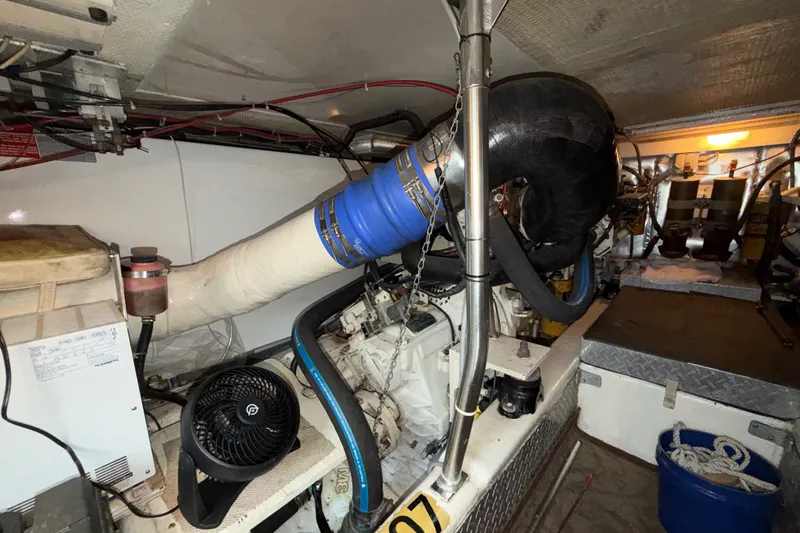 Slide: The Image of Engine room of a 2001 Ocean Yachts 48 Super Sport, showcasing mechanical components and wiring. - 63