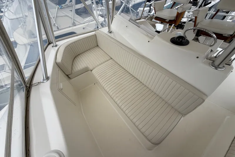 Slide: The Image of 2001 Ocean Yachts 48 Super Sport interior with white cushioned seating and helm area. - 22