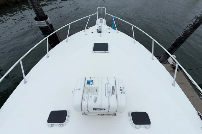 Slide: The Image of Bow view of 2001 Ocean Yachts 48 Super Sport docked at marina. - 53