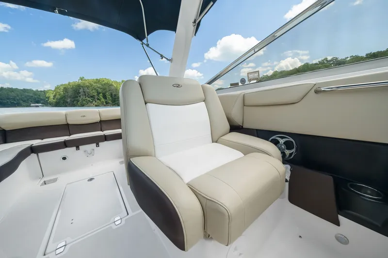 Slide: The Image of 2015 Regal 2700 ES Bowrider interior with beige seating and scenic lake view. - 14