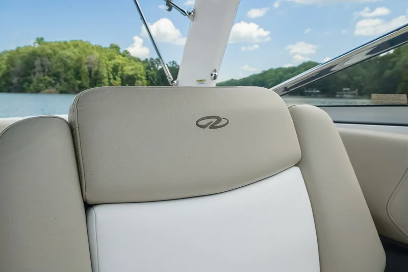 Slide: The Image of 2015 Regal 2700 ES Bowrider seat with logo, scenic lake view in background. - 13