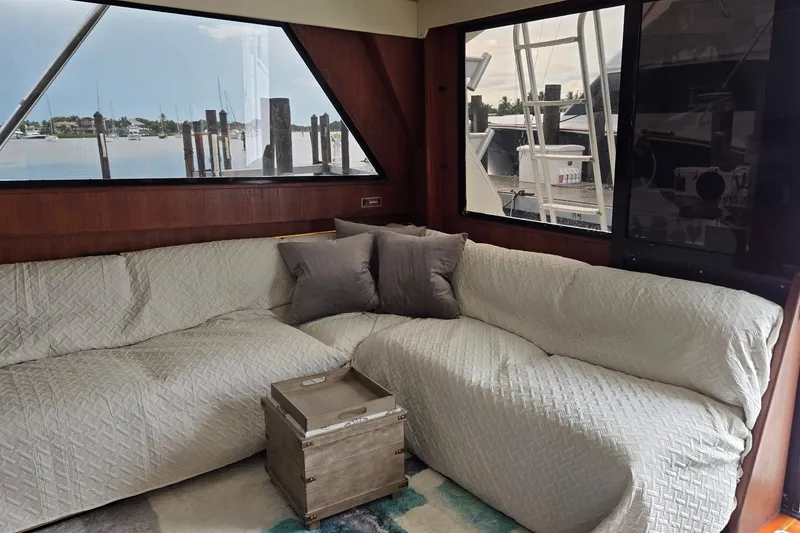 Slide: The Image of Interior of 1989 Viking 45 Convertible yacht with cozy seating and marina view. - 14
