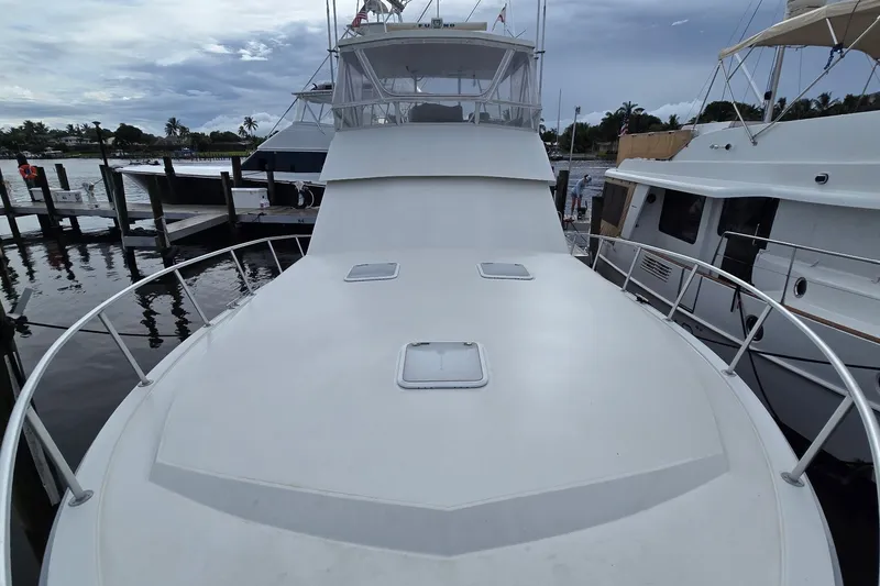 Slide: The Image of 1989 Viking 45 Convertible yacht docked at marina, view of spacious deck and flybridge. - 30