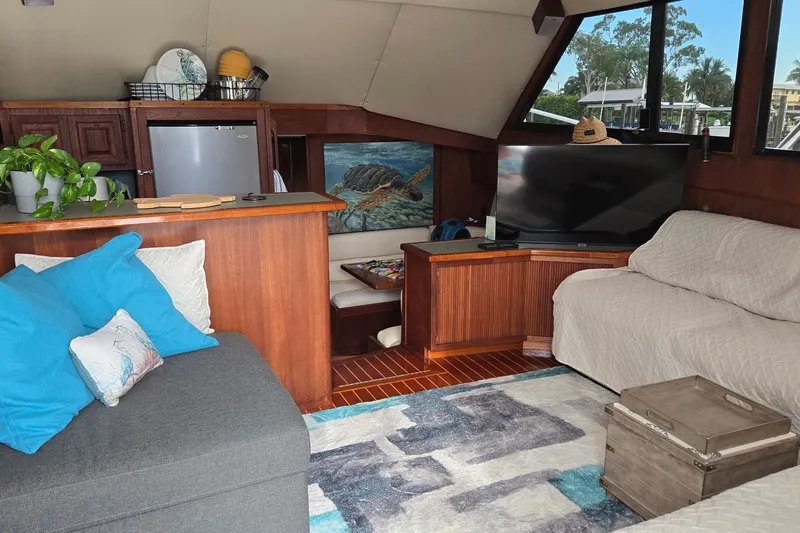 Slide: The Image of Interior of a 1989 Viking 45 Convertible yacht with cozy seating and decor. - 28
