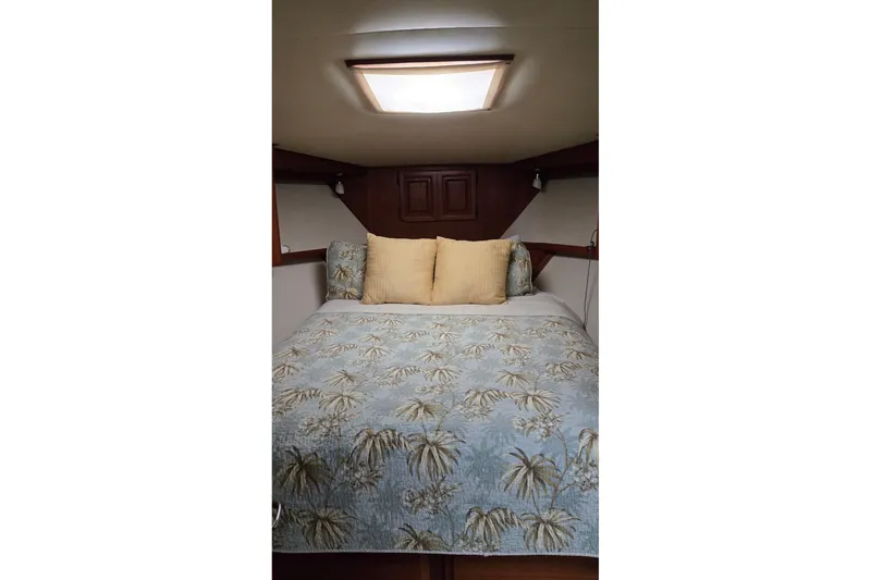 Slide: The Image of Cozy bedroom in 1989 Viking 45 Convertible yacht with floral bedding and soft lighting. - 26