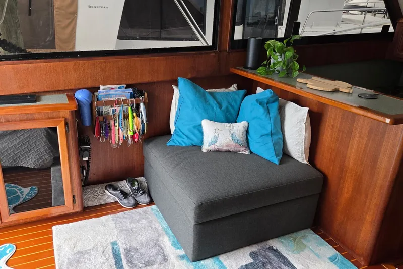 Slide: The Image of Cozy interior of 1989 Viking 45 Convertible yacht with seating, pillows, and fishing gear. - 16