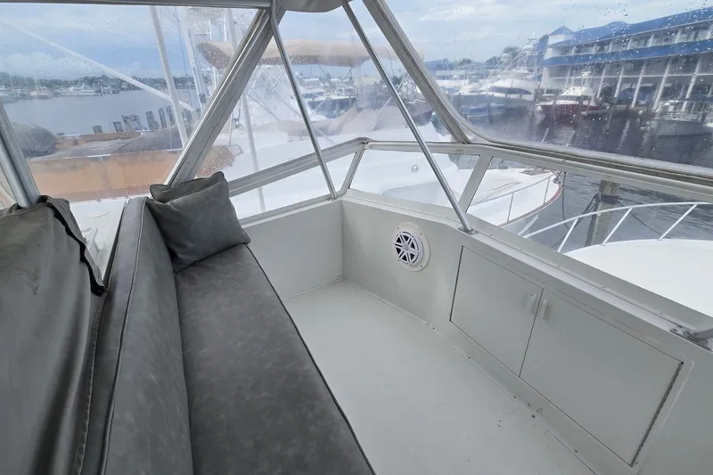 Slide: The Image of Enclosed seating area on 1989 Viking 45 Convertible yacht with marina view. - 10