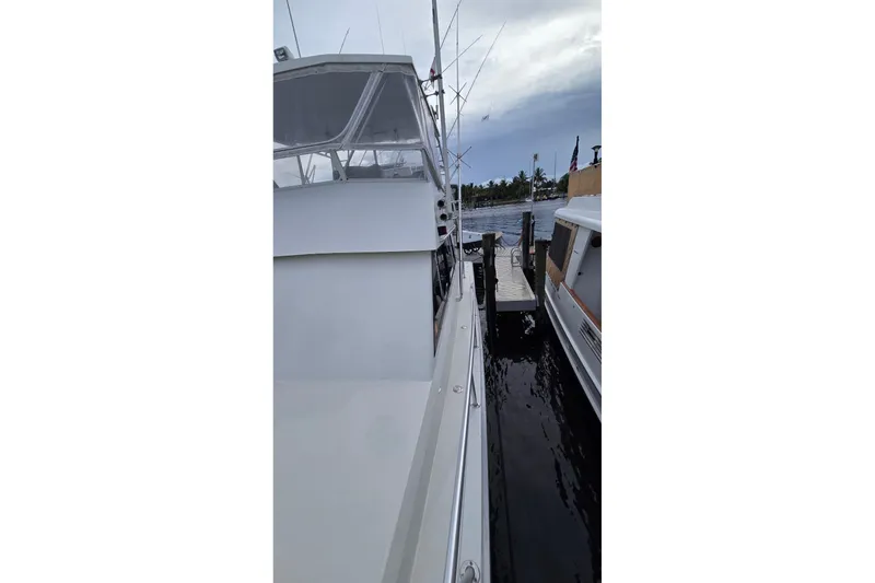 Slide: The Image of 1989 Viking 45 Convertible yacht docked at marina, side view. - 34