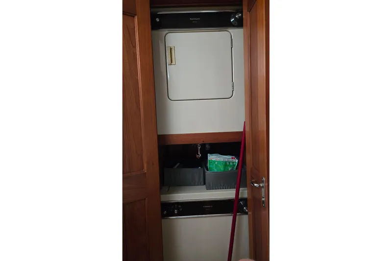 Slide: The Image of Laundry area inside 1989 Viking 45 Convertible yacht with stacked washer and dryer. - 24