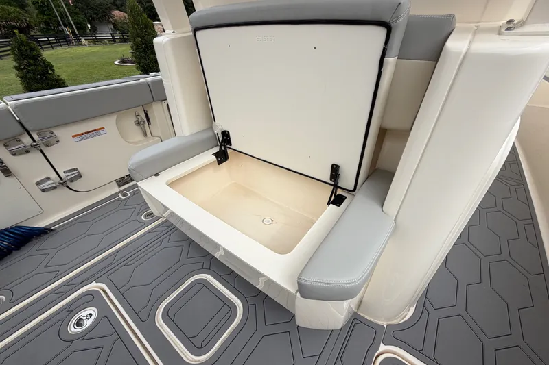 Slide: The Image of 2026 Scout 330 LXF boat interior with open storage compartment and cushioned seating. - 30