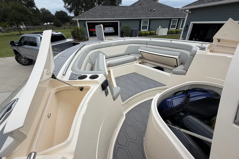 Slide: The Image of 2026 Scout 330 LXF boat interior with seating and storage compartments. - 18