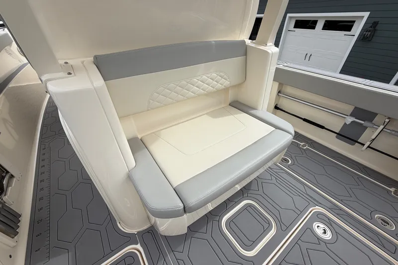 Slide: The Image of 2026 Scout 330 LXF boat interior with cushioned seating and modern flooring design. - 29