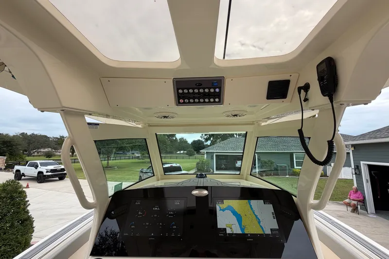 Slide: The Image of Interior view of 2026 Scout 330 LXF boat with navigation display and control panel. - 38
